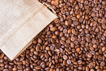 Coffee grains scatter out of the bag. The background of coffee beans_