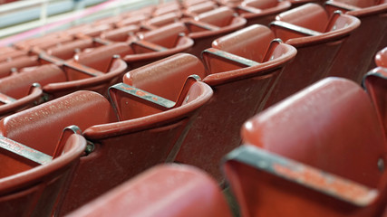 Empty stadium with red folding metal seats © martyweil