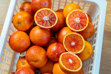 fresh red oranges in plastic crate top view b