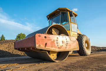 Heavy construction machinery performs work on a construction site
