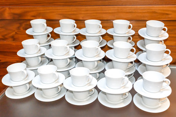 Obraz na płótnie Canvas Many Empty White Tea Or Coffee Cups Stacked On The Table. Event Catering Service.