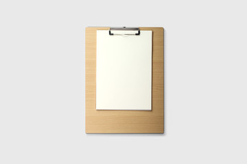 Clipboard with a sheet of white paper isolated on soft gray background.High resolution photo.