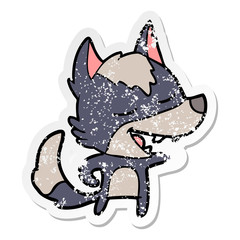 distressed sticker of a cartoon wolf laughing