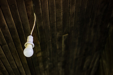 Old lamp hanging in old cabin.