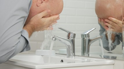 Tired Man in Bathroom Washing His Face with Fresh Water from Sink Faucet