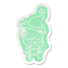 cartoon distressed sticker of a crying girl wearing santa hat