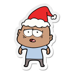 sticker cartoon of a tired bald man wearing santa hat