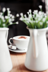 Cup of cappuccino on a wooden table