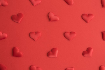 Flat lay of hearts decoration on red background abstract.