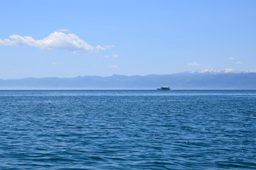 Tourist ship is sailing on Ohrid Lake. Mountain background. Ohrid,