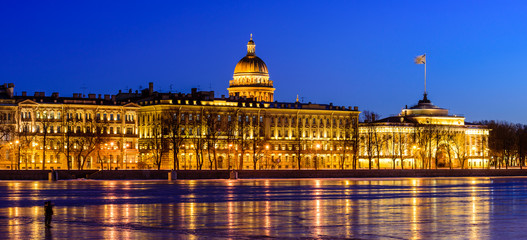 Neva river embankment panoramic landscape in Saint Petersburg. St. Isaac's Cathedral and the buildings on the waterfront in beautiful night lighting, Saint-Petersburg, Russia