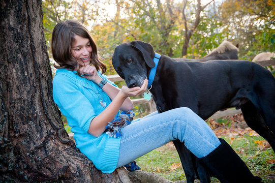 Girl Feeds Her Dog A Treat