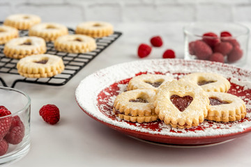 Obraz na płótnie Canvas Pretty heart shape cookies with berries on red plate