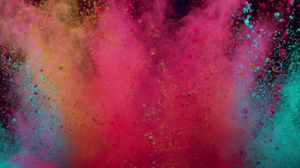 Super slowmotion shot of color powder explosion isolated on blue background.