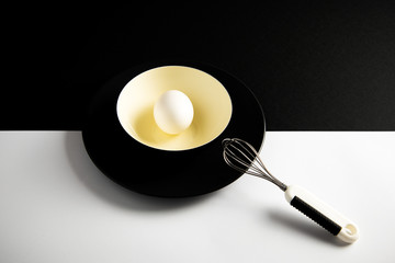 White egg on a yellow bowl.