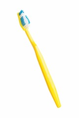 Yellow toothbrush on a white background