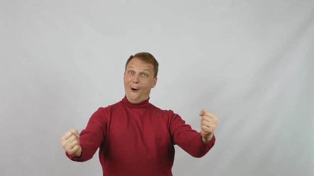 Young handsome man in red sweater posing for the camera