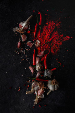 Fresh red and spicy chilli peppers on dark background. Flat lay. From above