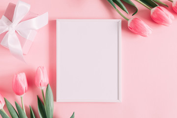Flowers composition romantic. Flowers pink tulips, photo frame on pastel pink background. Wedding. Birthday. Happy woman's day. Mothers Day. Valentine's Day. Flat lay, top view, copy space