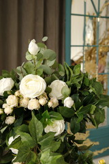 bouquet of white roses against a gray rough wall