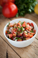 Close-up of spicy salsa dip on a wooden table
