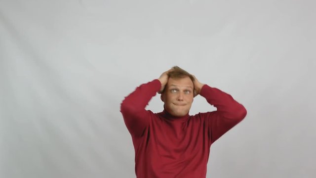 Young handsome man in red sweater posing for the camera