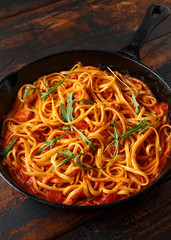 Spaghetti alla Amatriciana with pancetta bacon, tomatoes and pecorino cheese. served in cast iron skillet.