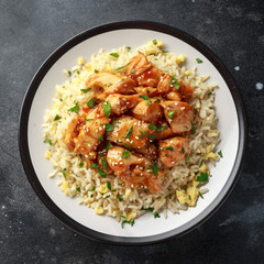 Orange Chicken Spicy sweet and sour with fried eggs rice in a plate