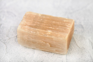 Natural mineral - rough Selenite, Gypsum crystal from Kungur, Ural, Russia on white cement background.