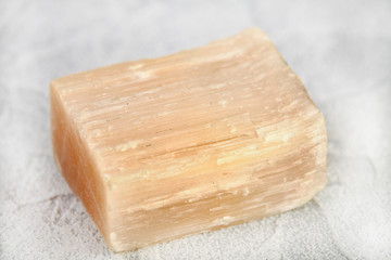Natural mineral - rough Selenite, Gypsum crystal from Kungur, Ural, Russia on white cement background.