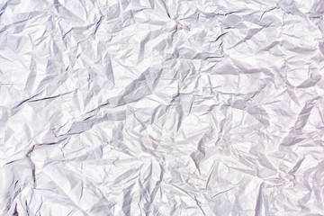 Texture of crumpled white paper close up. Blank abstract background.