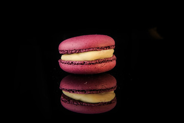 single purple berry macaroon with yellow filling