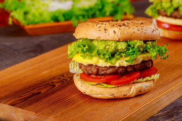 Fresh homemade gourmet beef burger on cutting board