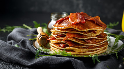 Pancakes with crispy bacon and maple syrup in a plate. Morning Breakfast