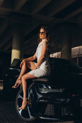 Obraz na płótnie Canvas Luxury professional fashion model with new sport car outdoors. Fashion, transport, luxury concept