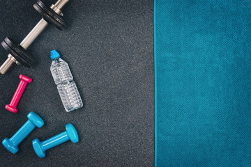 Fitness or bodybuilding concept background. Product photograph of old iron dumbbells on black grey,...