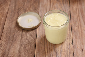 Homemade natural cream on wooden surface, copy space