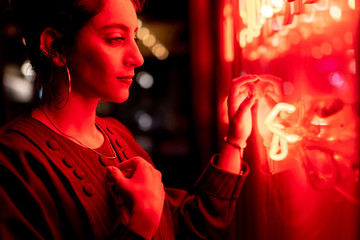 Lady near red neon lights