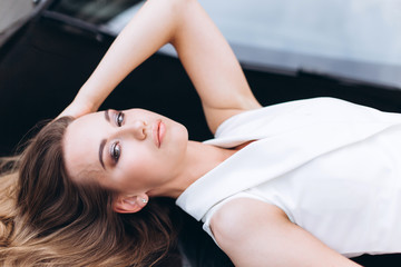 Obraz premium Luxury professional fashion model with new sport car outdoors. Fashion, transport, luxury concept