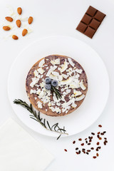 Blueberry - chocolate cheesecake on a white wooden table