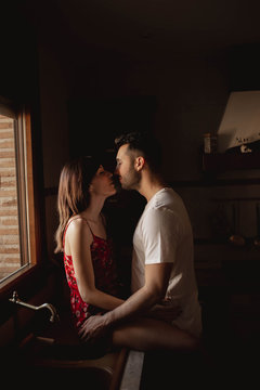 Happy couple kissing in kitchen