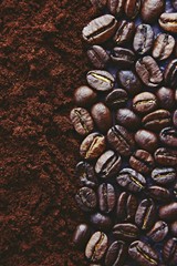 Roasted coffee beans background. Close up coffee beans and ground coffee 