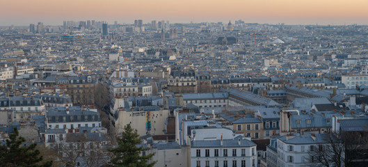 Fototapeta premium Paris, France - 02 24 2019: Montmartre at sunset. View of Paris from sacred heart