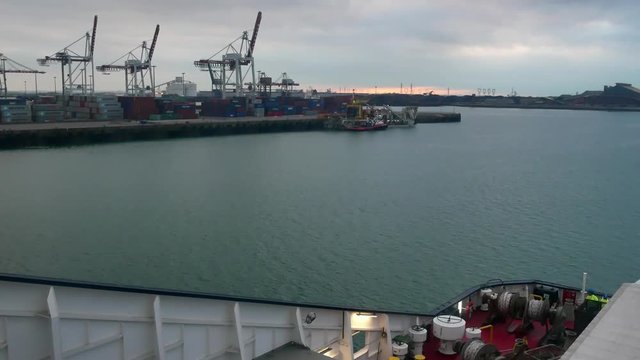 A ferry leaves the harbor Dunkirk towards Great Britain front of cranes