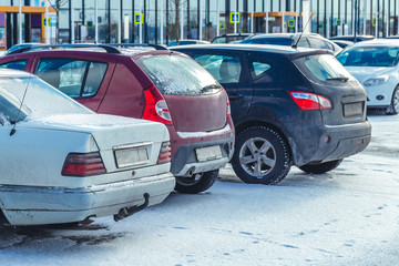 Parked used cars in the parking lot in winter