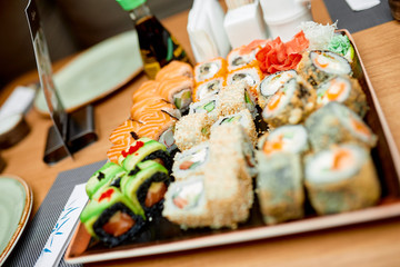 a set of sushi with wasabi ginger and a glass of whiskey