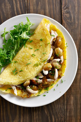 Omelet with mushrooms, chicken meat, greens