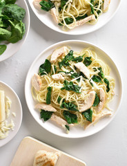 Spaghetti with spinach leaves, grilled chicken breast and cheese