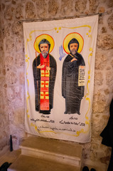 Mardin / Turkey - May 17 / 2015 :  A painting of two saints on a curtain in Mor Gabriel Deyrulumur Monastery