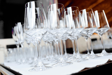 empty wine glasses on a white tablecloth on a table